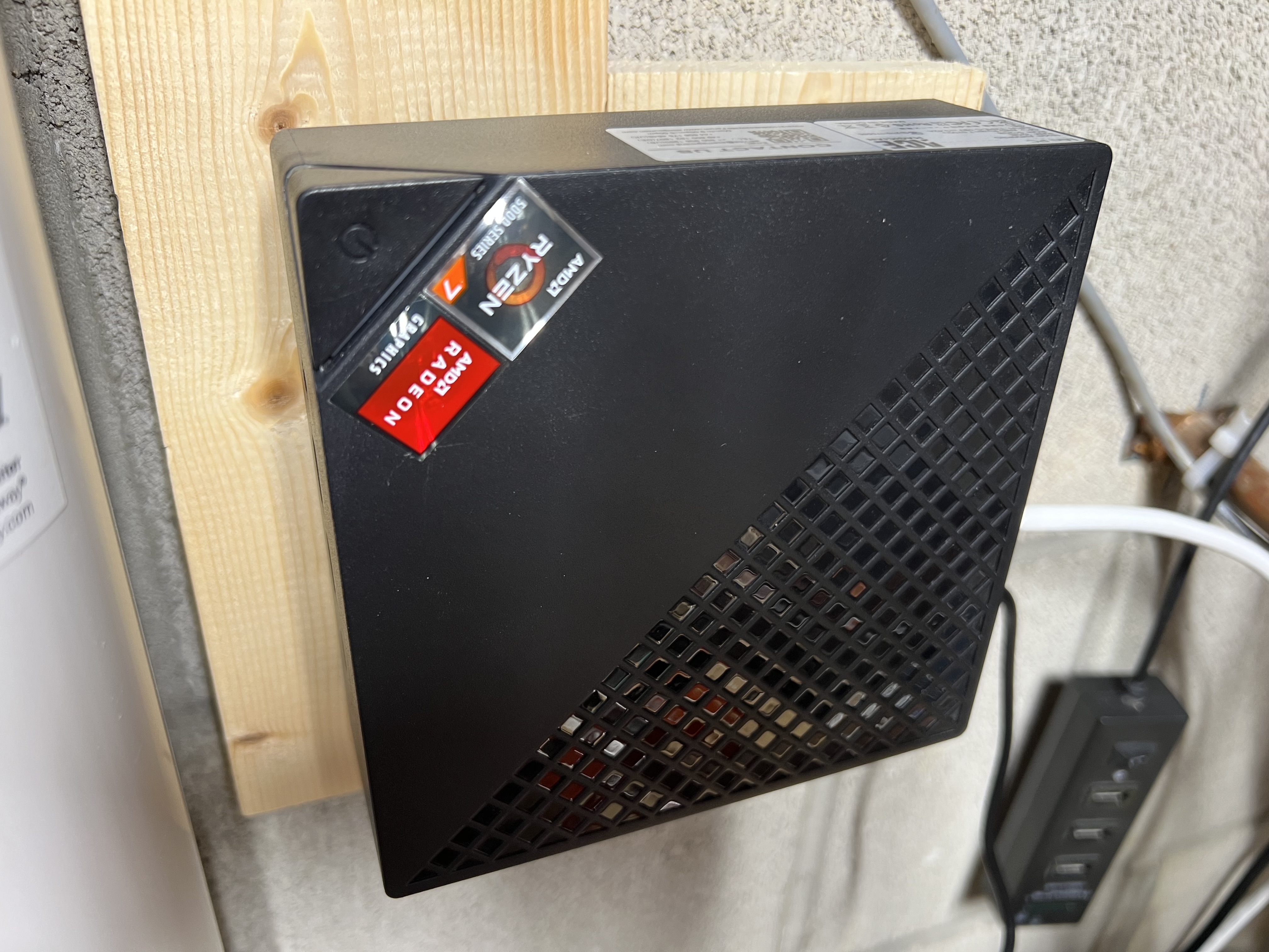 Homelab server wall-mounted next to the workbench